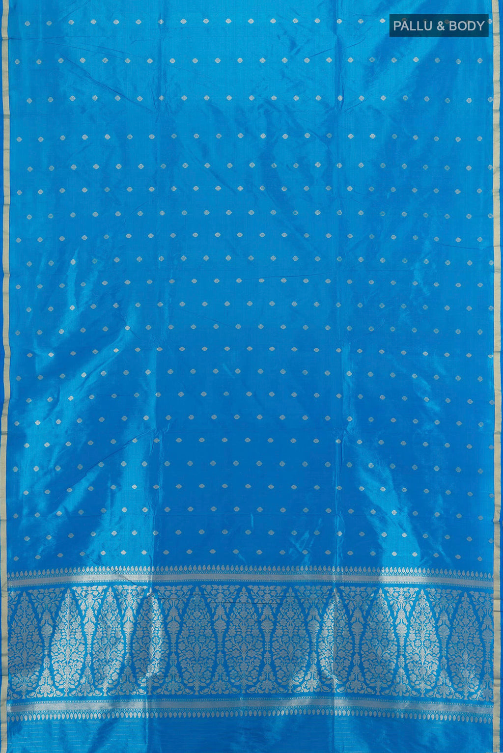 Flat view of Sky Blue Banarasi Katan Silk Saree with Zari Butta on the body and Zari Border. 