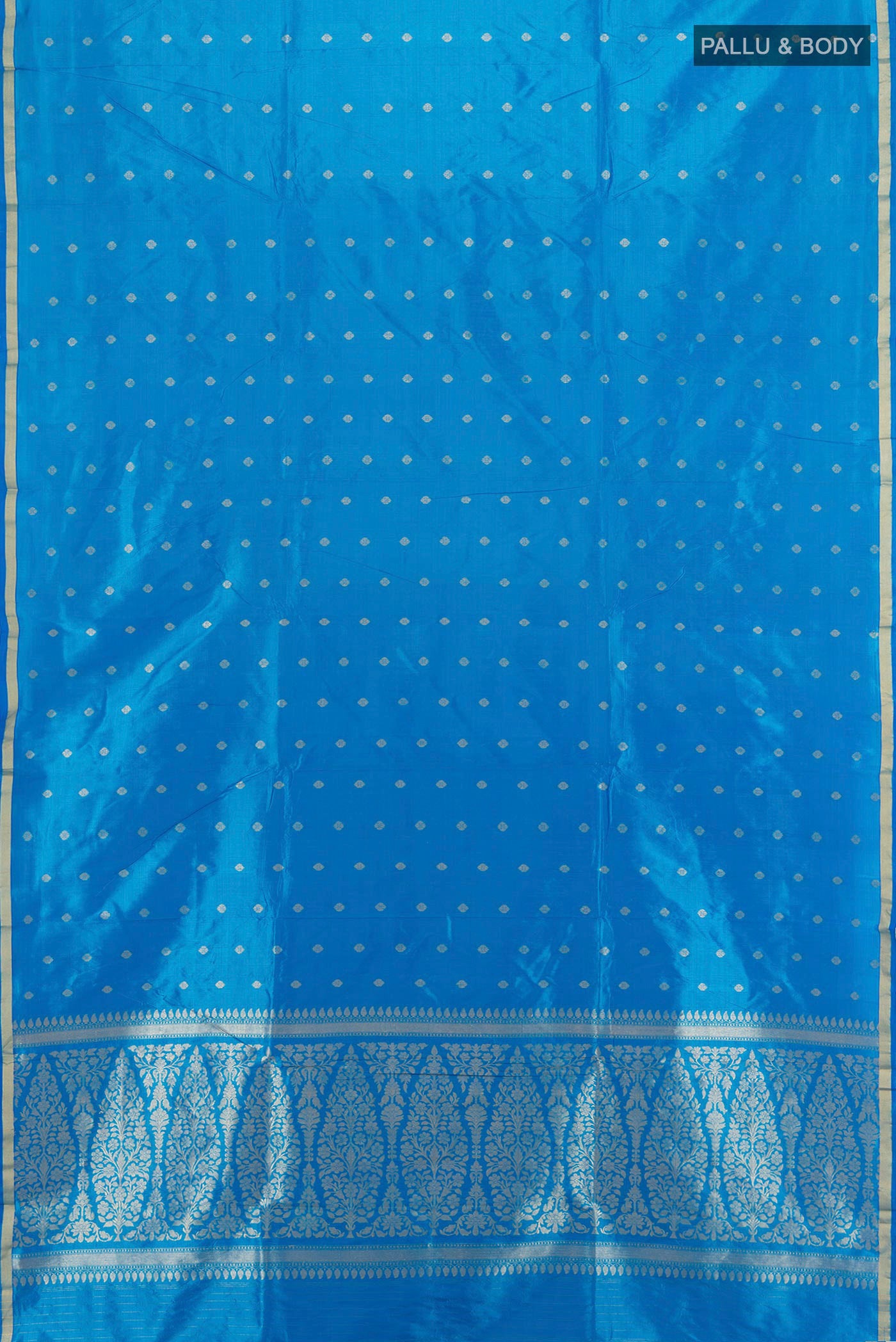 Flat view of Sky Blue Banarasi Katan Silk Saree with Zari Butta on the body and Zari Border. 