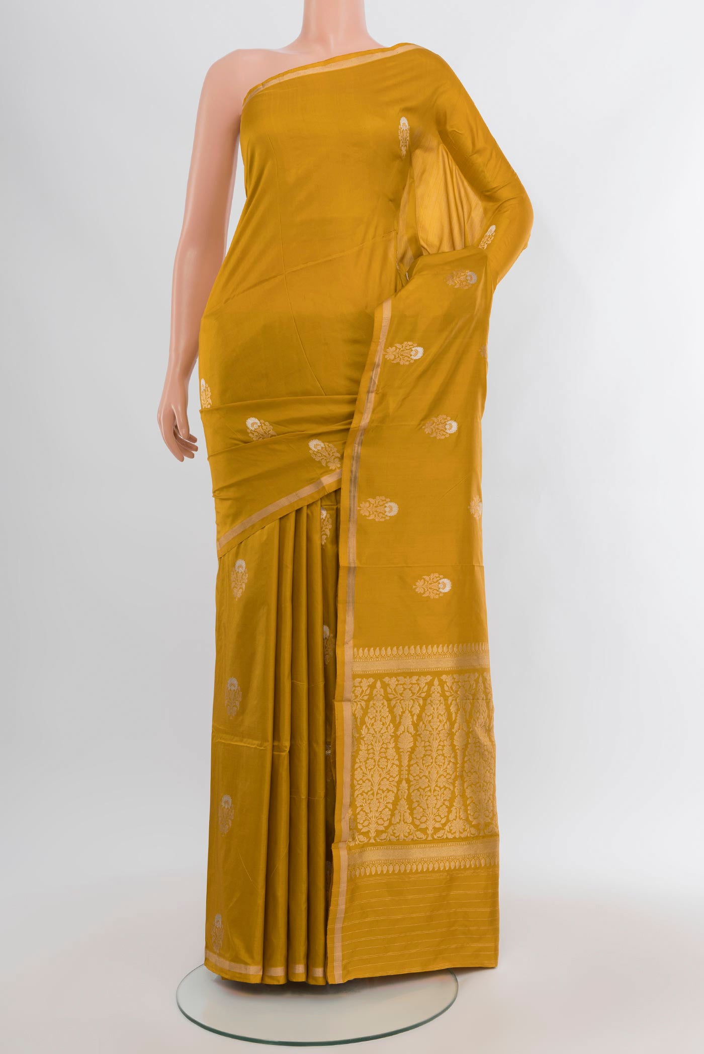 Mustard Banarasi Katan Silk Saree with Zari Butta on the body and Zari Border.  displayed on a mannequin