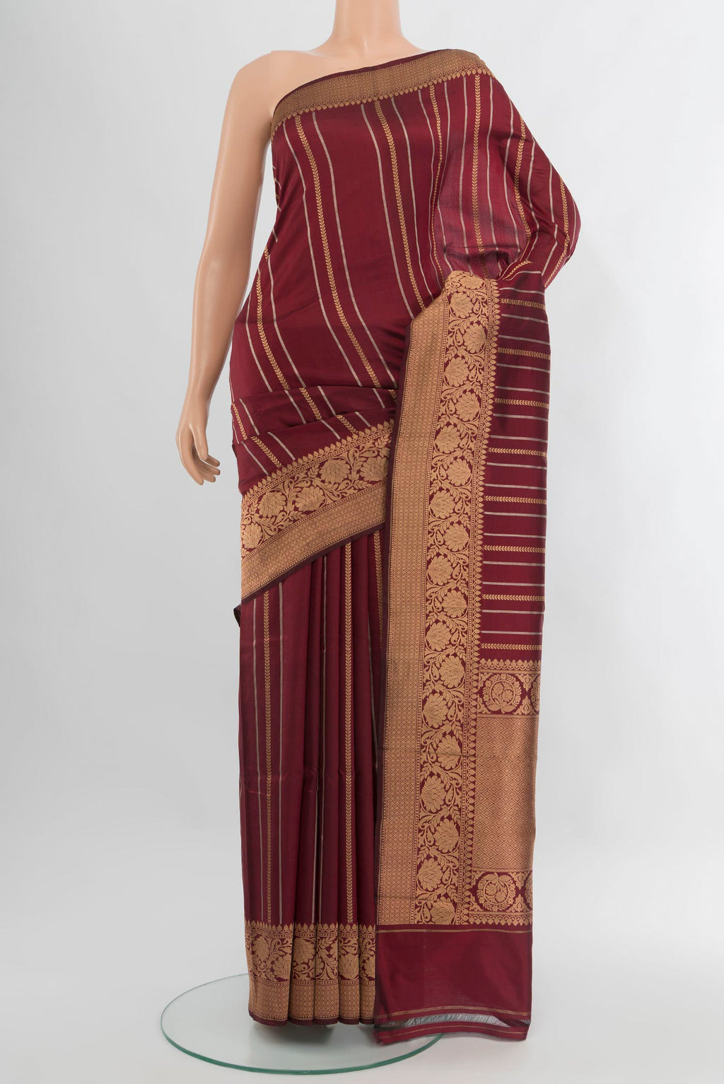 Maroon Banarasi Katan Silk Saree with Stripes on the body and Zari Border.  displayed on a mannequin