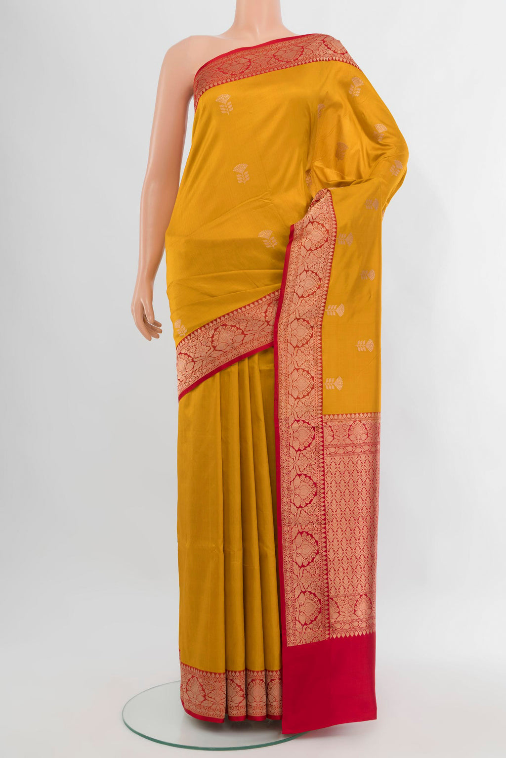 Mustard Banarasi Katan Silk Saree with Zari Butta on the body and Zari Border.  displayed on a mannequin