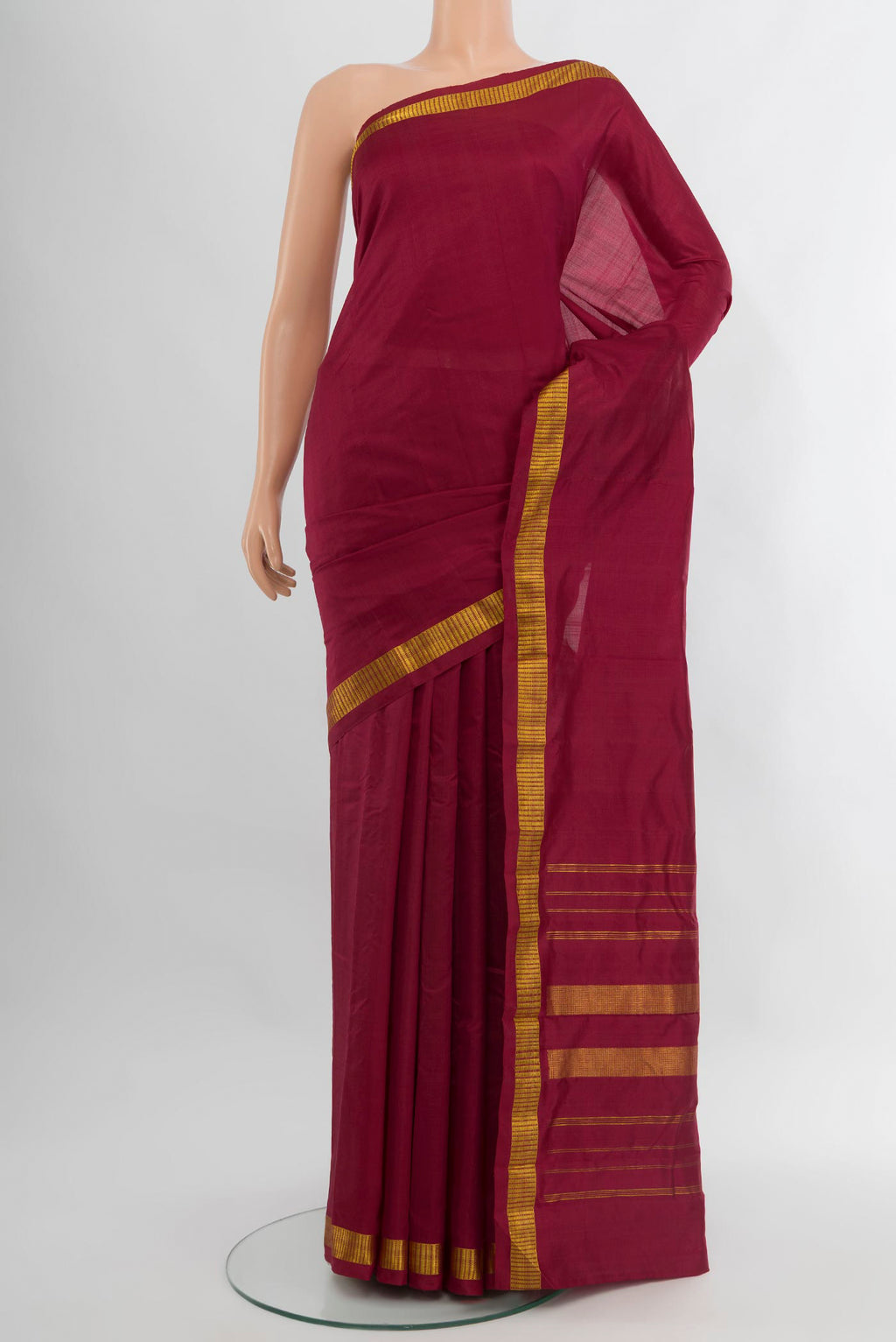 Maroon Kanchipuram Silk Saree with Plain Body and Zari Border.  displayed on a mannequin