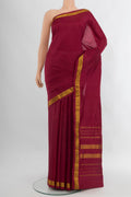 Maroon Kanchipuram Silk Saree with Plain Body and Zari Border.  displayed on a mannequin
