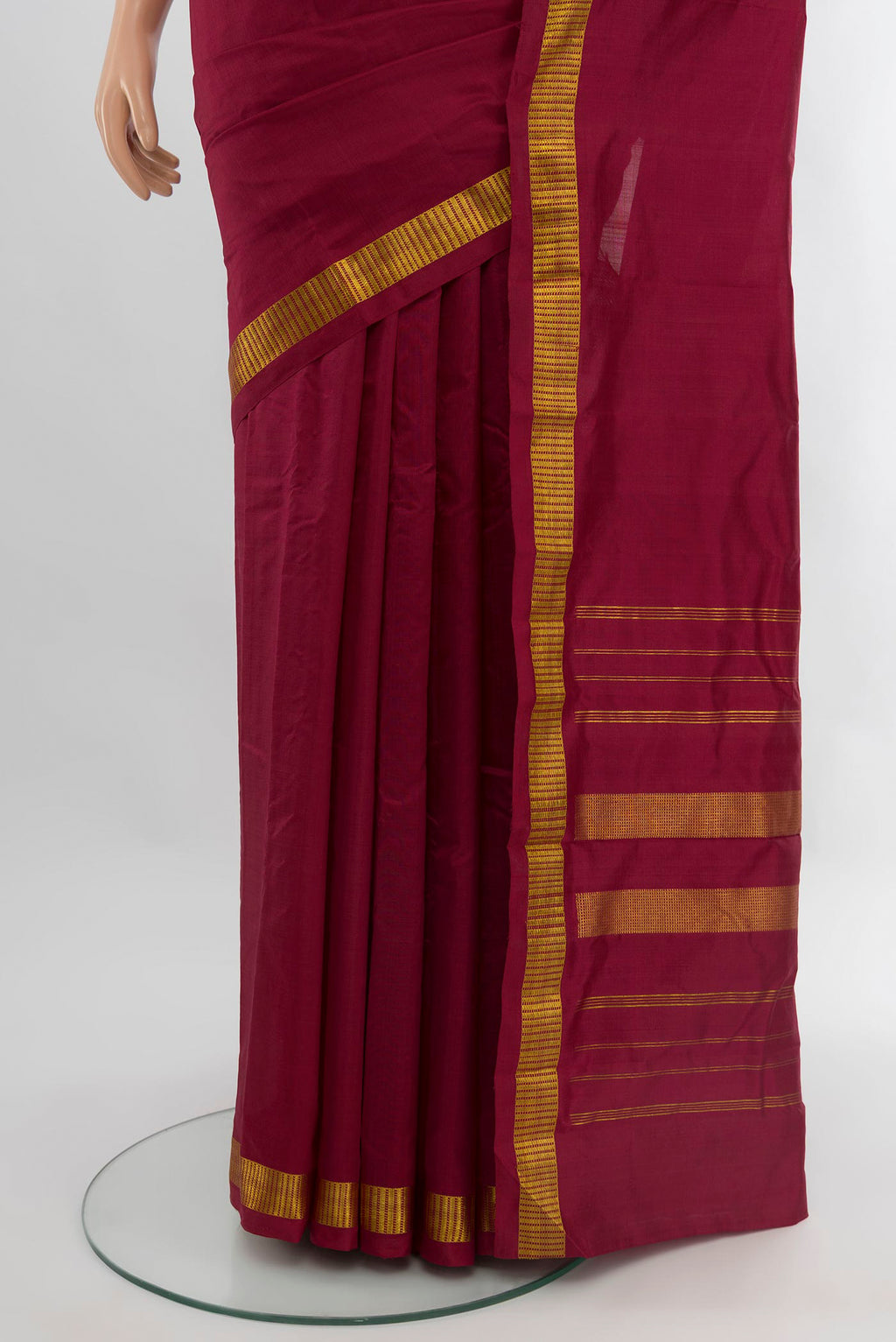 Pleats and pallu of Maroon Kanchipuram Silk Saree with Plain Body and Zari Border. 