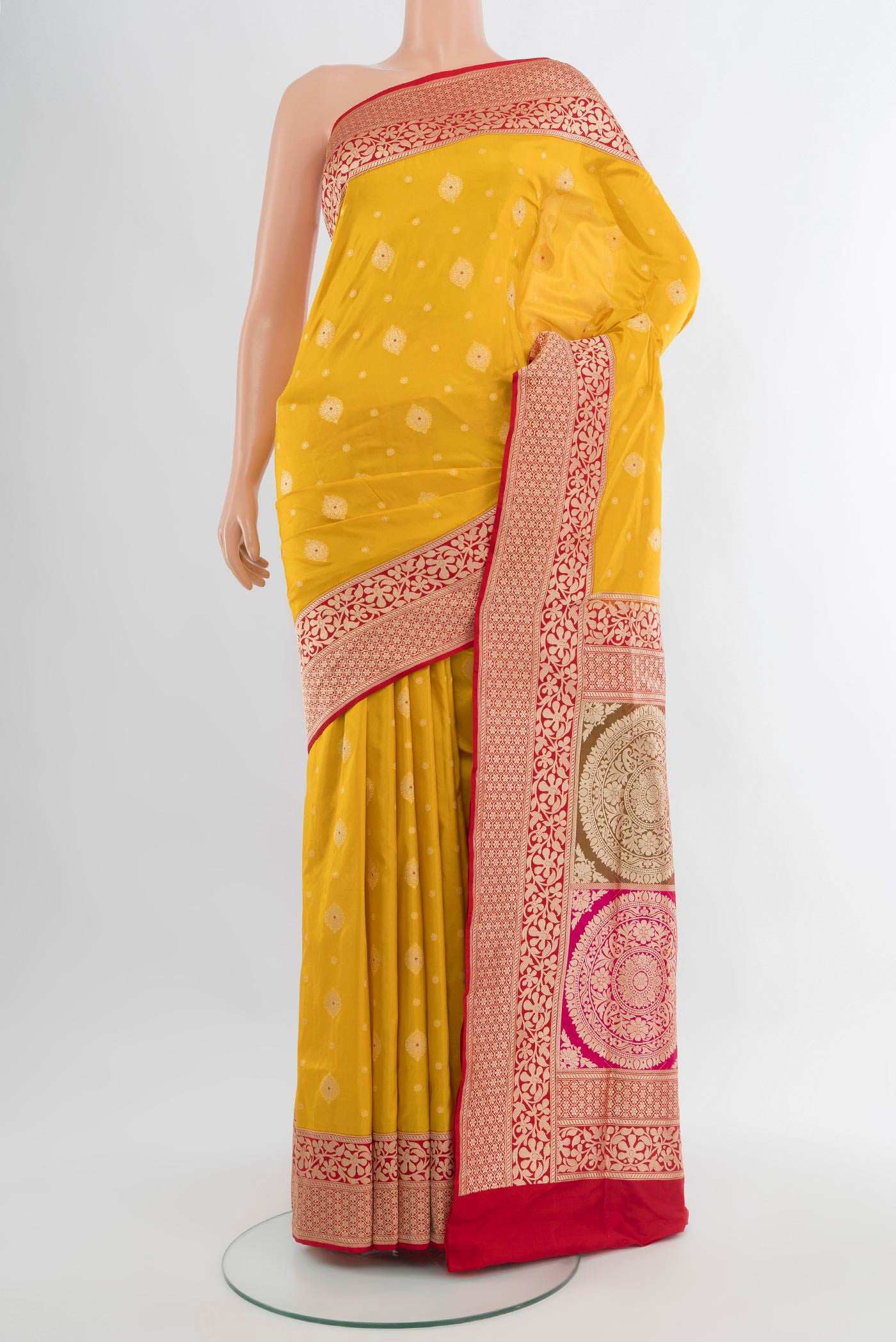 Yellow Banarasi Silk Saree with Zari Butta on the body and Zari Border.  displayed on a mannequin