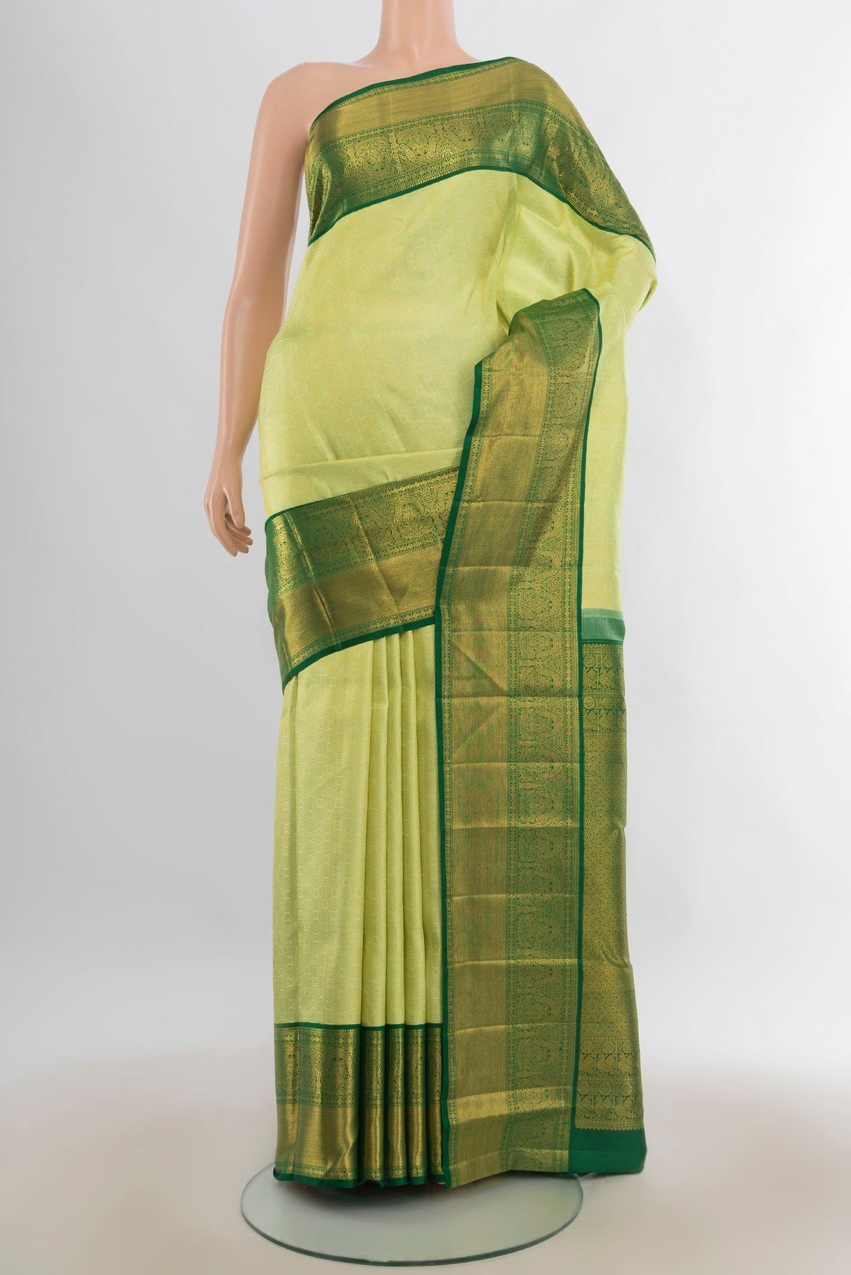 Pure Silk Pista Green Kanchipuram Saree with Zari Brocade on the body and Zari Border.  displayed on a mannequin