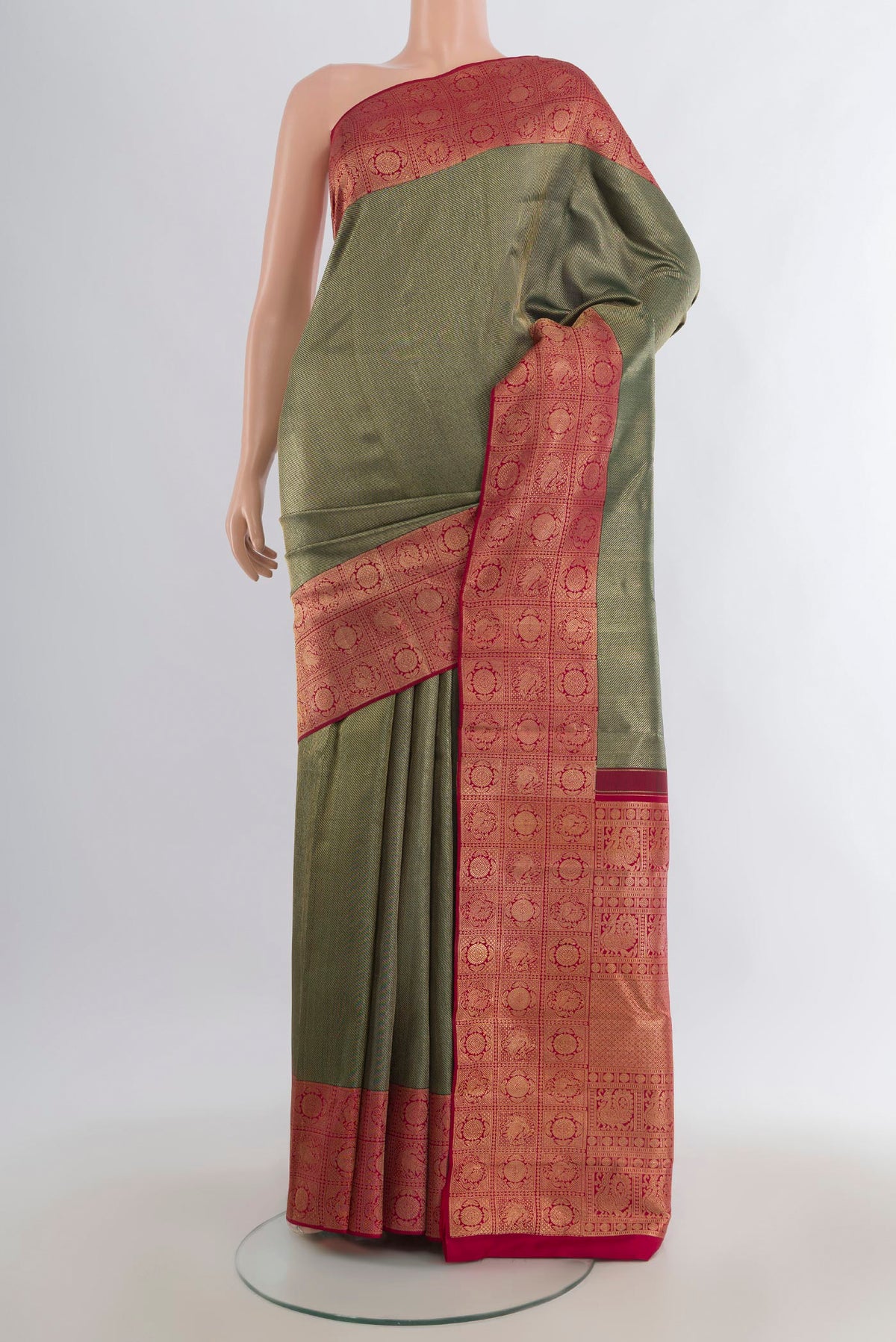 Pure Silk Bottle Green Kanchipuram Saree with Zari Brocade on the body and Zari Border.  displayed on a mannequin