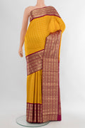 Yellow Kanchipuram Silk Saree with Zari Butta on the body and Zari Border.  displayed on a mannequin