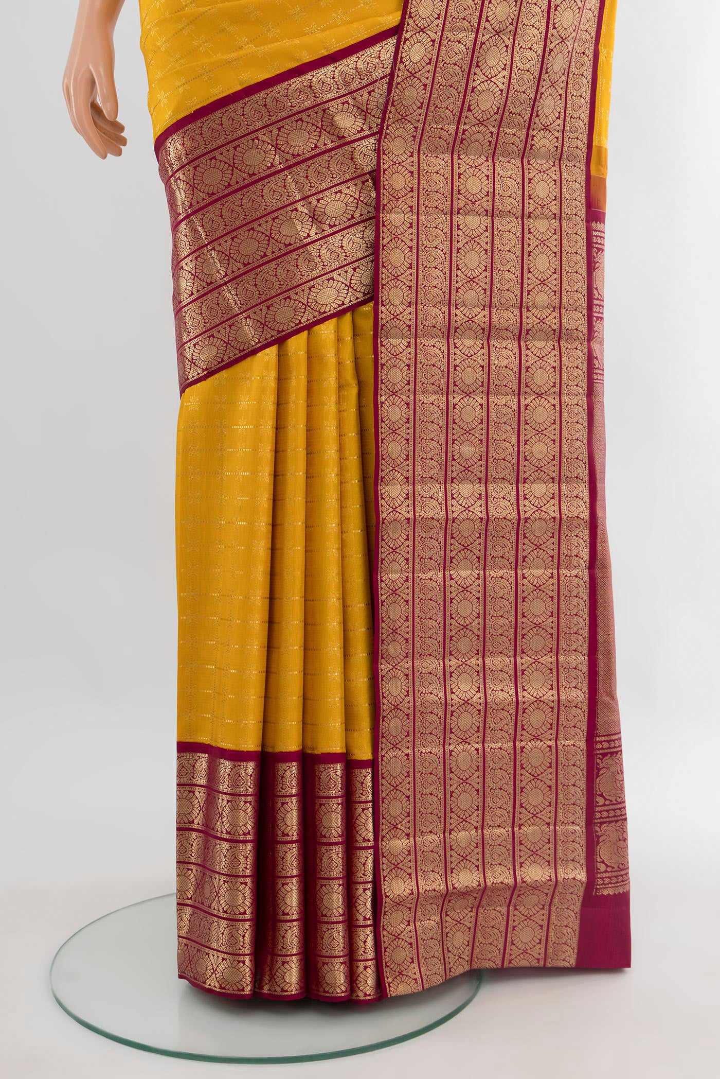 Pleats and pallu of Yellow Kanchipuram Silk Saree with Zari Butta on the body and Zari Border. 