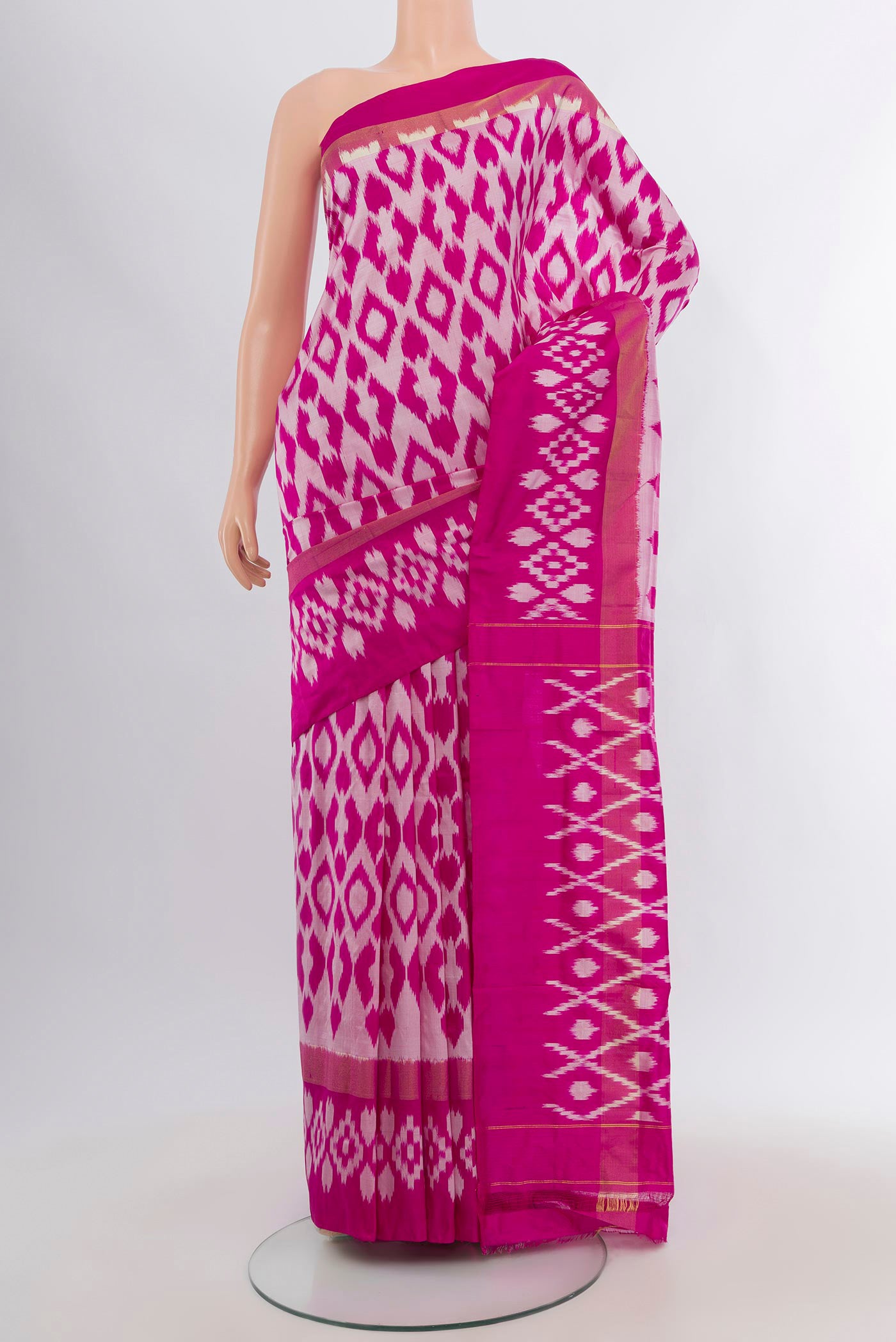 Magenta Pochampally Silk Saree with Ikat design on the body and Plain Border.  displayed on a mannequin
