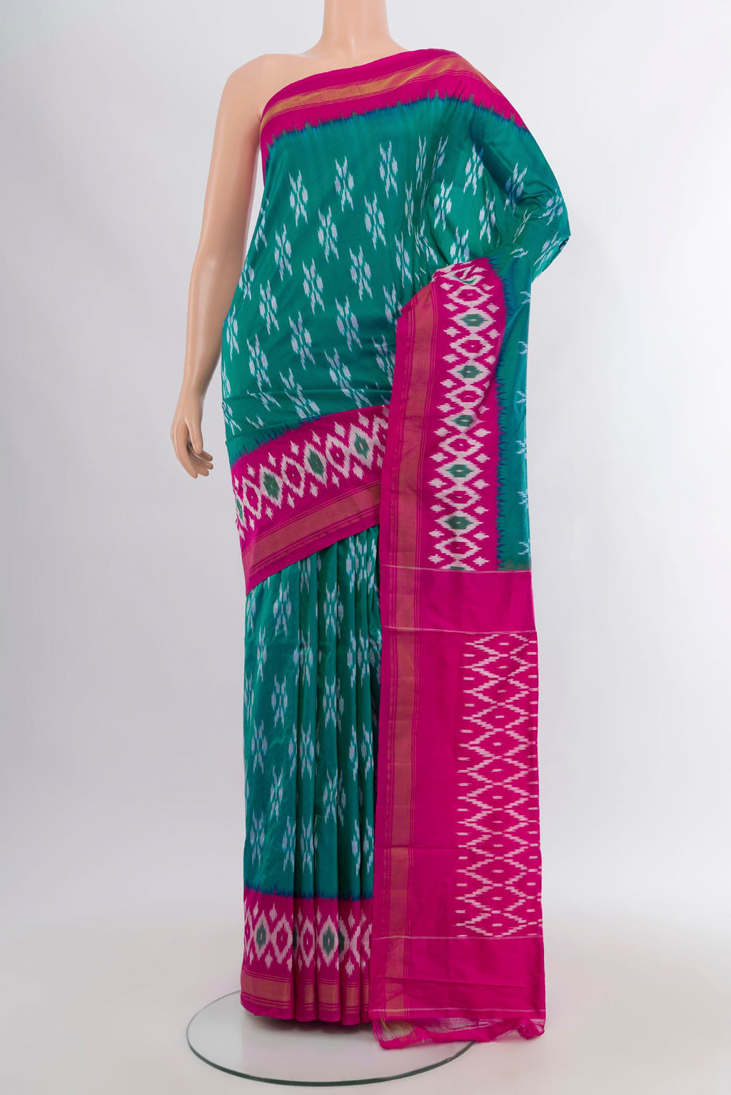 Teal Pochampally Silk Saree with Ikat design on the body and Ikat Border.  displayed on a mannequin