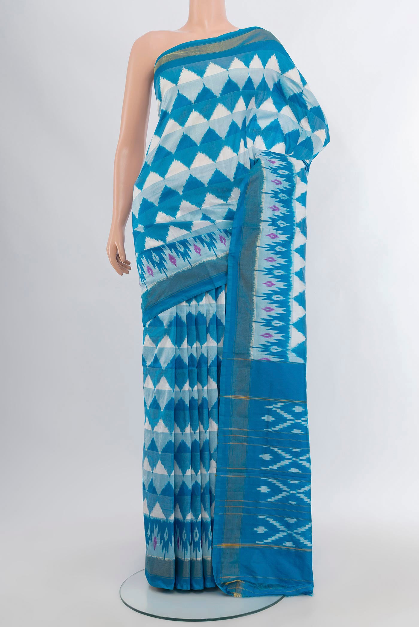 Sky Blue Pochampally Silk Saree with Ikat design on the body and Zari Border.  displayed on a mannequin