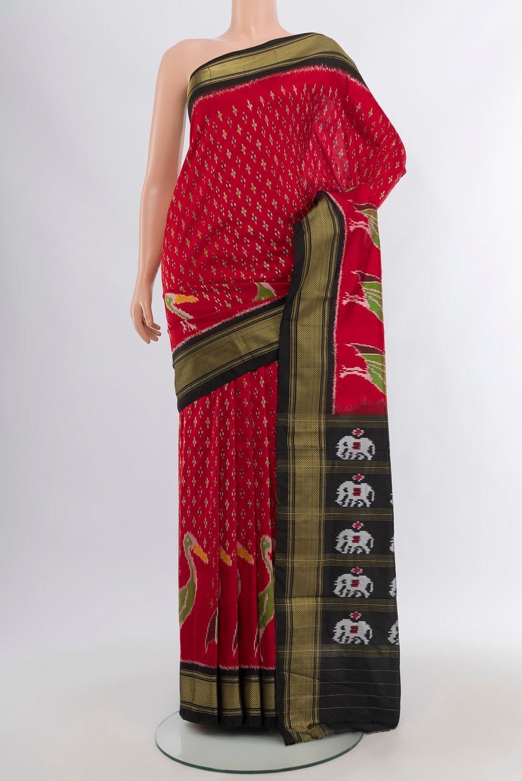 Red Pochampally Silk Saree with Ikat design on the body and Zari Border.  displayed on a mannequin