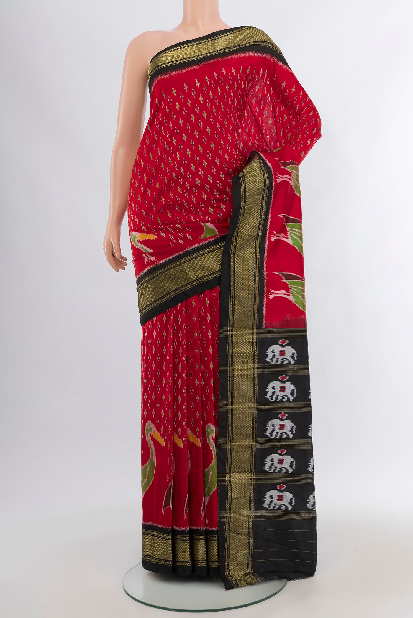 Red Pochampally Silk Saree with Ikat design on the body and Zari Border.  displayed on a mannequin