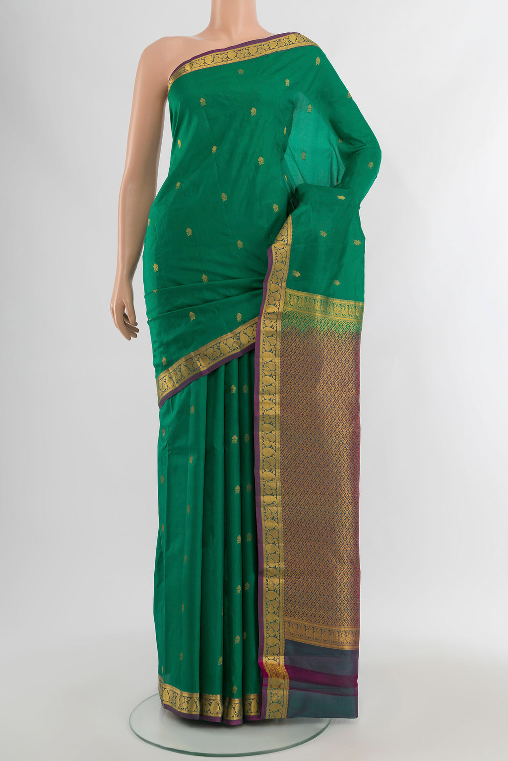 Green Kanjivaram Silk Saree with Zari Butta on the body and Zari Border.  displayed on a mannequin