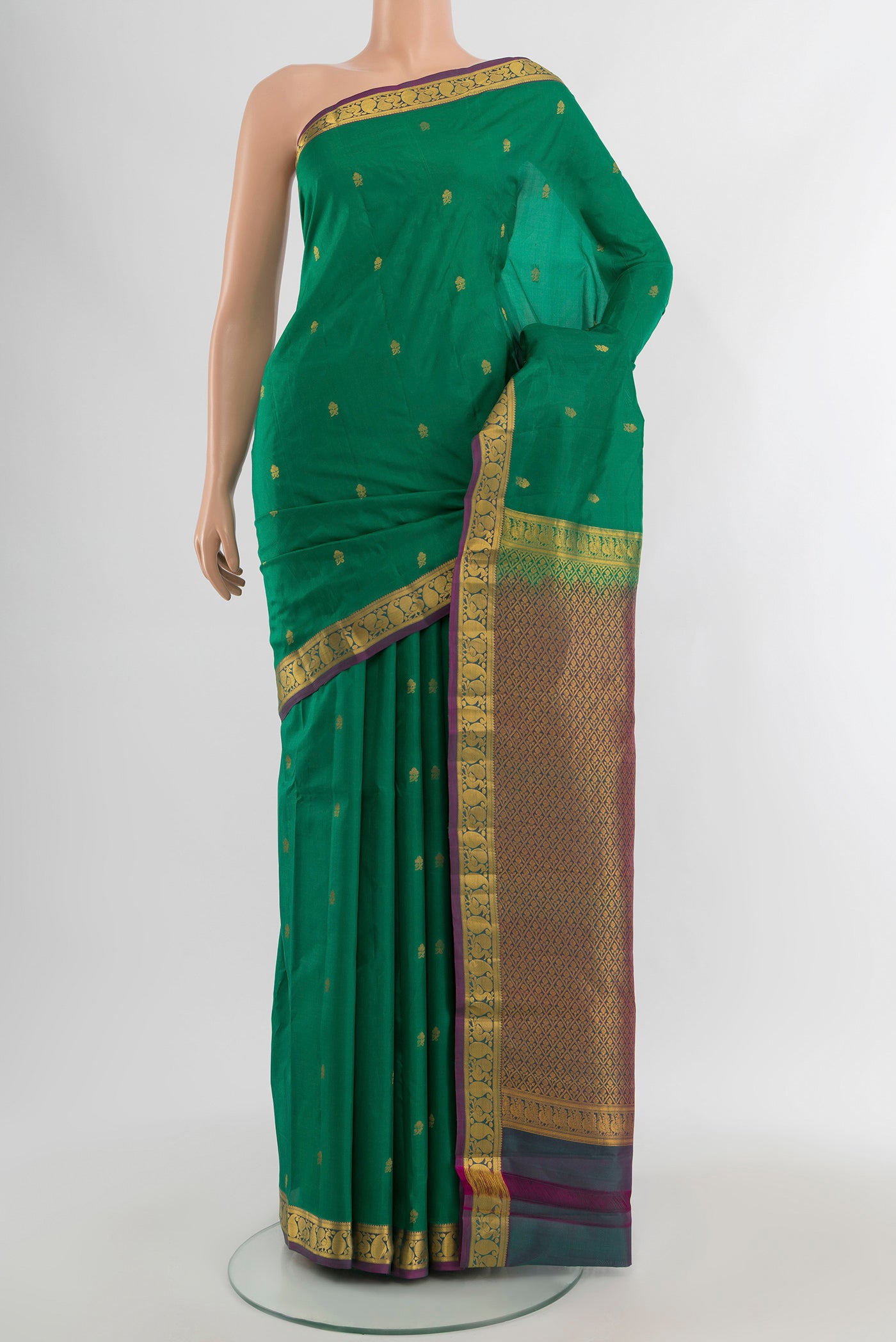 Green Kanjivaram Silk Saree with Zari Butta on the body and Zari Border.  displayed on a mannequin