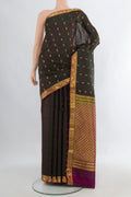 Pure Silk Bottle Green Kanjivaram Saree with Zari Butta on the body and Zari Border.  displayed on a mannequin