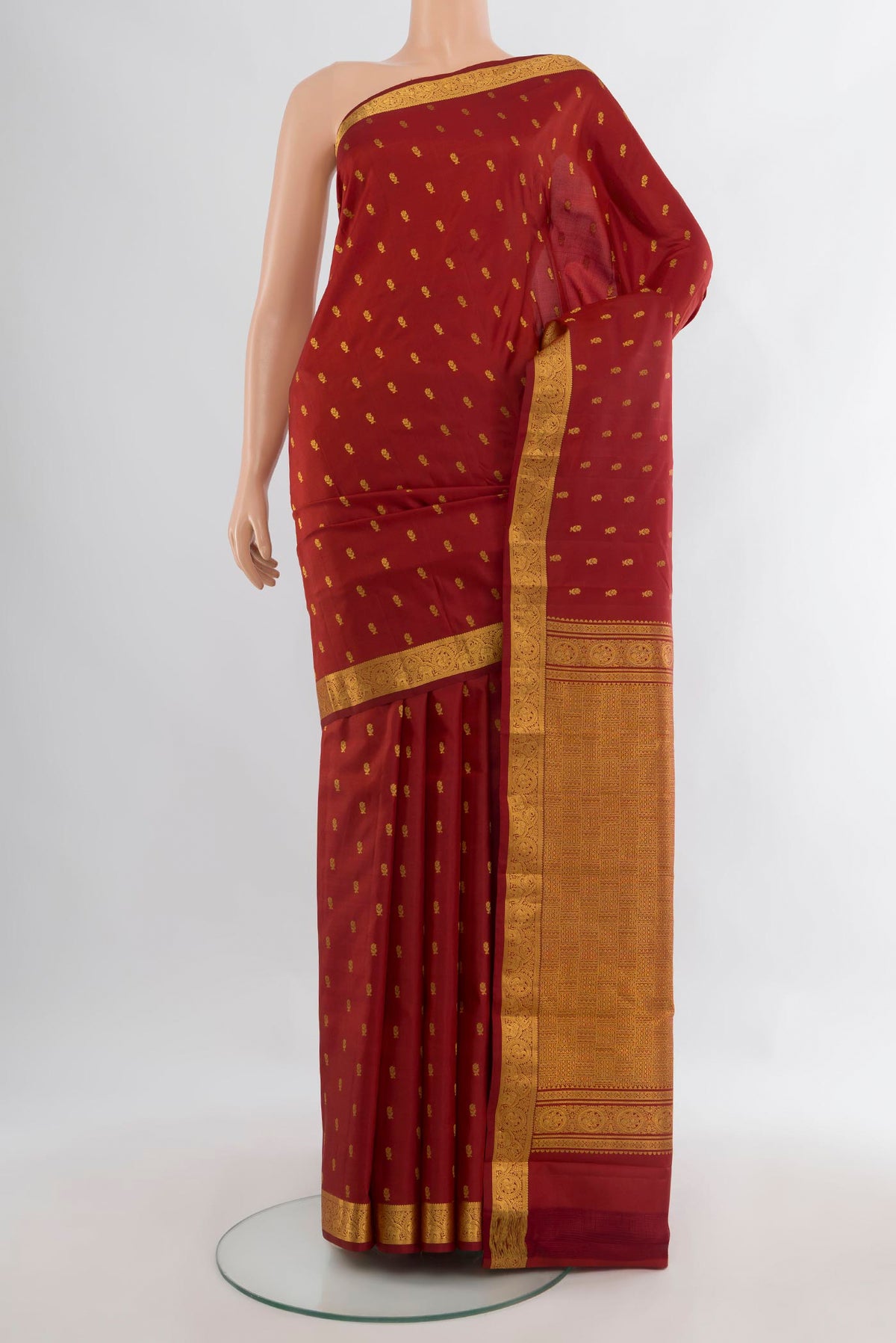 Pure Silk Maroon Kanchipuram Saree with Zari Butta on the body and Zari Border.  displayed on a mannequin