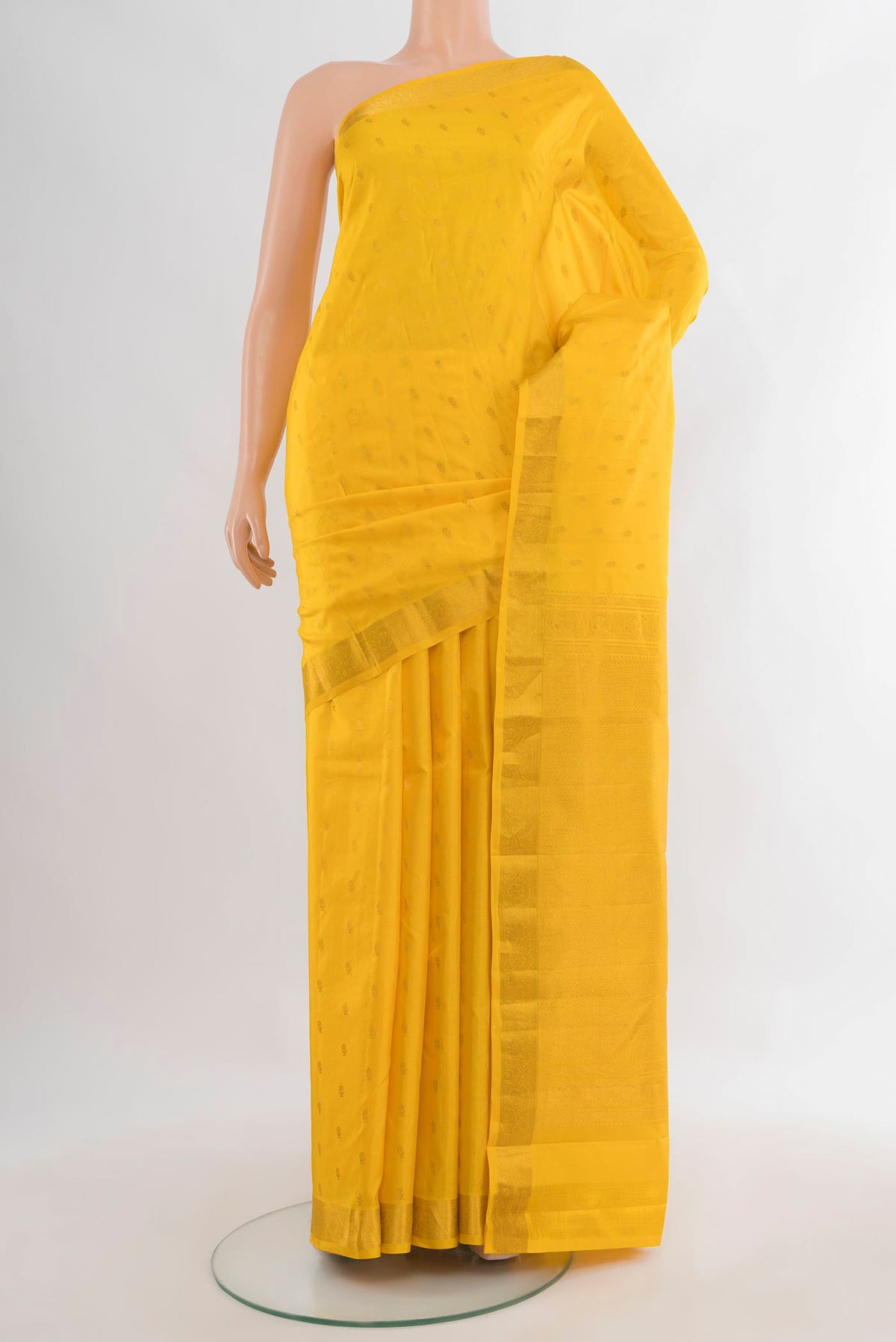 Pure Silk Yellow Kanchipuram Saree with Zari Butta on the body and Zari Border.  displayed on a mannequin