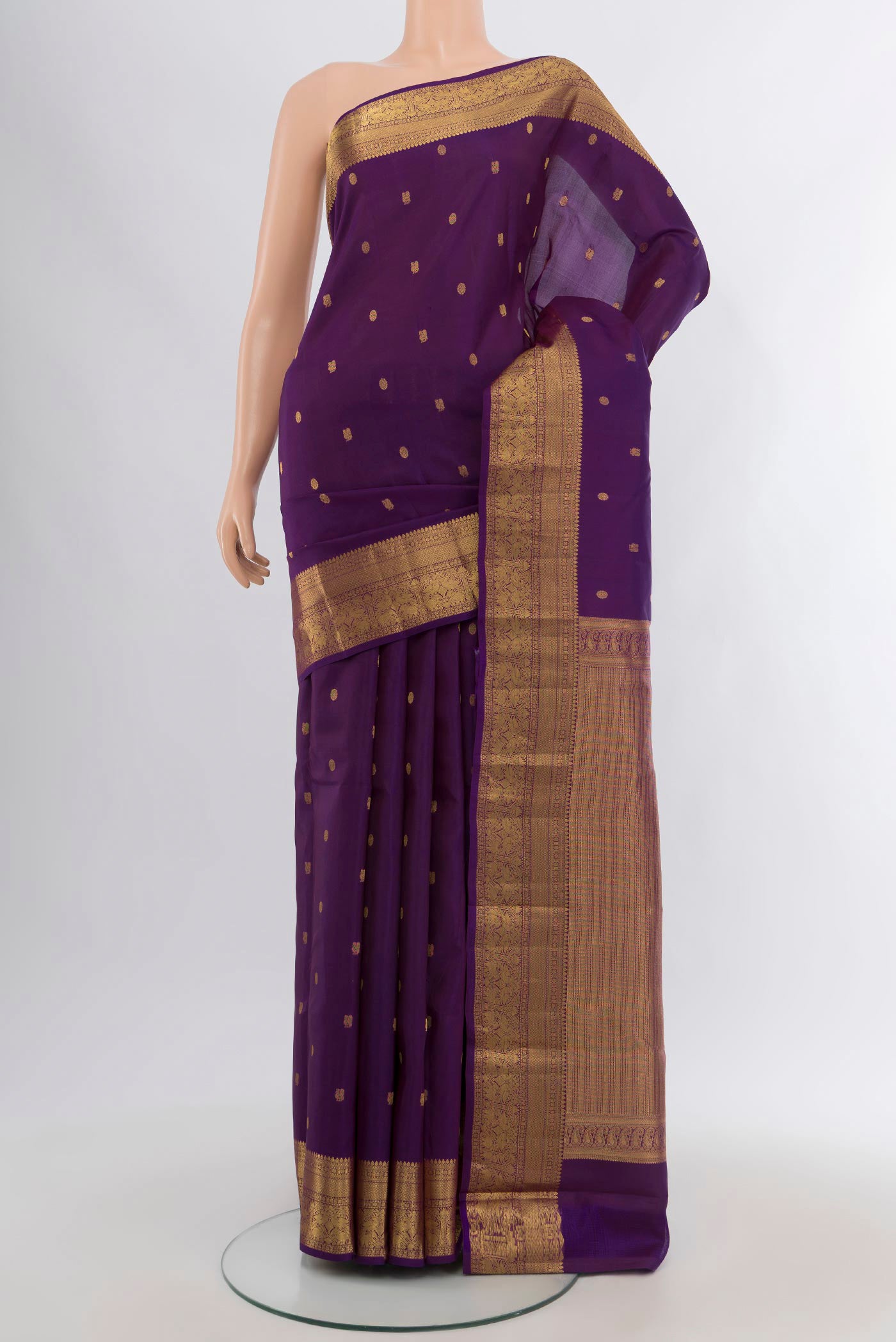 Violet Kanchipuram Silk Saree with Zari Butta on the body and Zari Border.  displayed on a mannequin