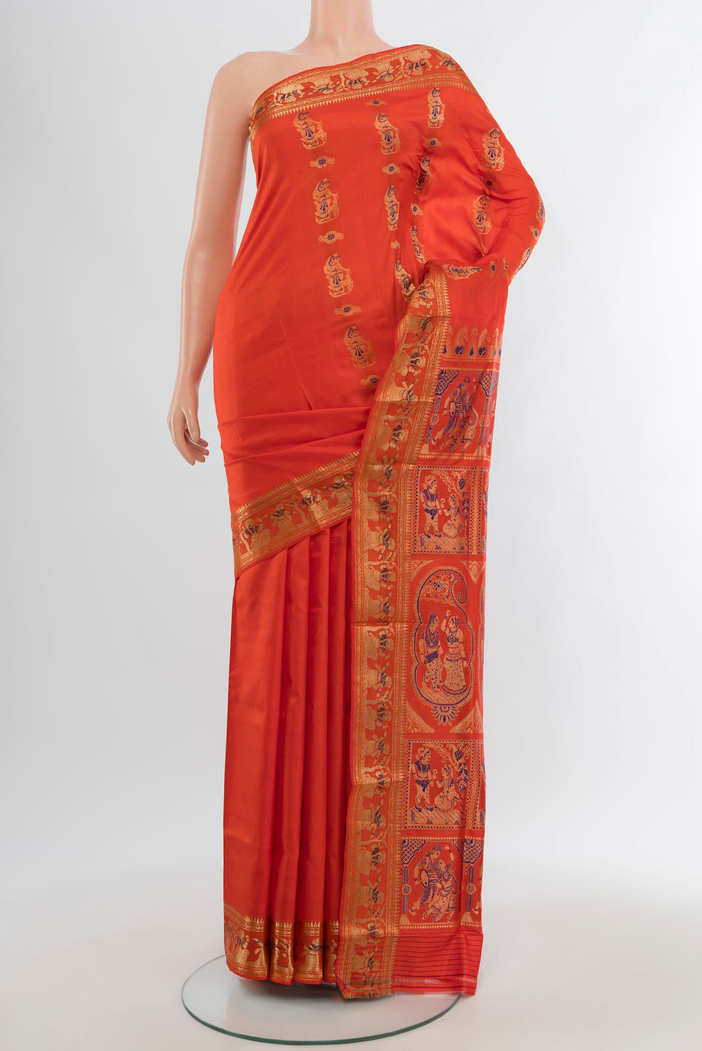Orange Baluchari Silk Saree with Zari And Thread Butta on the body and Zari Border.  displayed on a mannequin
