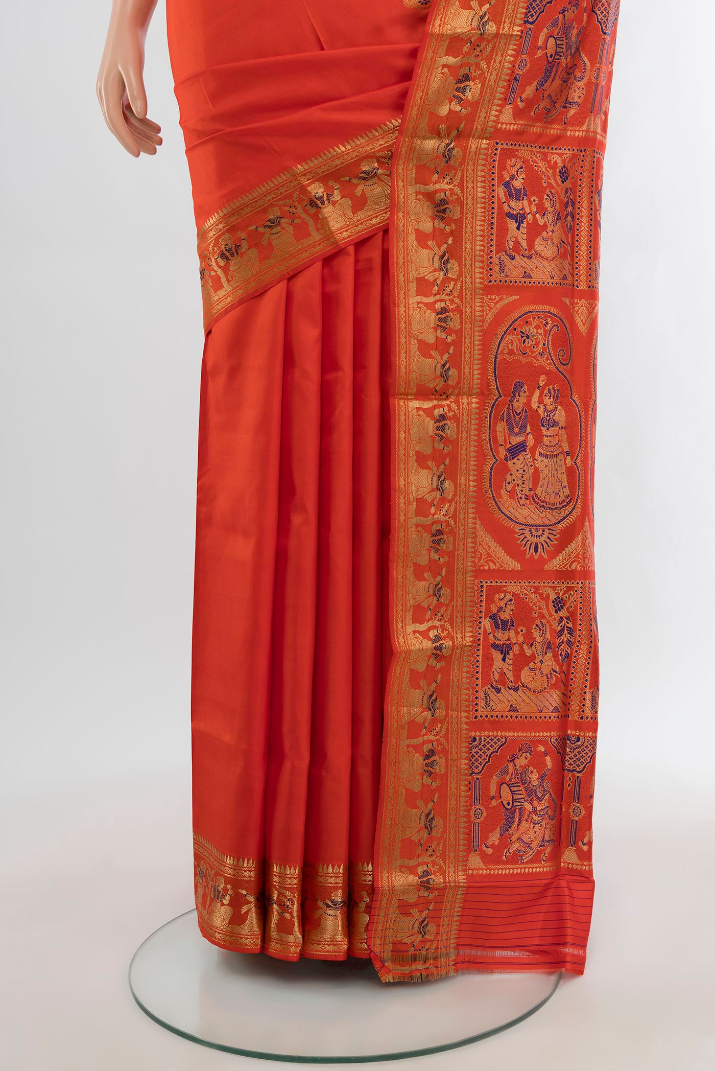 Pleats and pallu of Orange Baluchari Silk Saree with Zari And Thread Butta on the body and Zari Border. 
