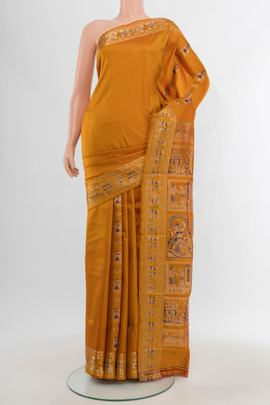 Mustard Baluchari Silk Saree with Zari And Thread Butta on the body and Zari Border.  displayed on a mannequin