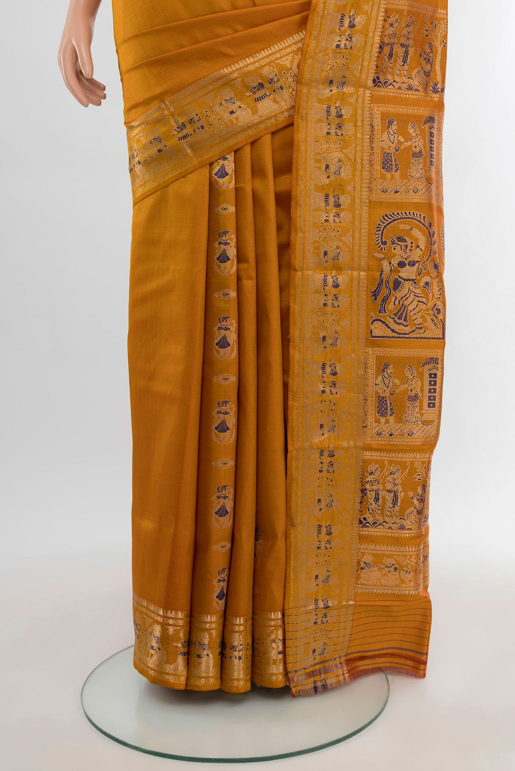 Pleats and pallu of Mustard Baluchari Silk Saree with Zari And Thread Butta on the body and Zari Border. 