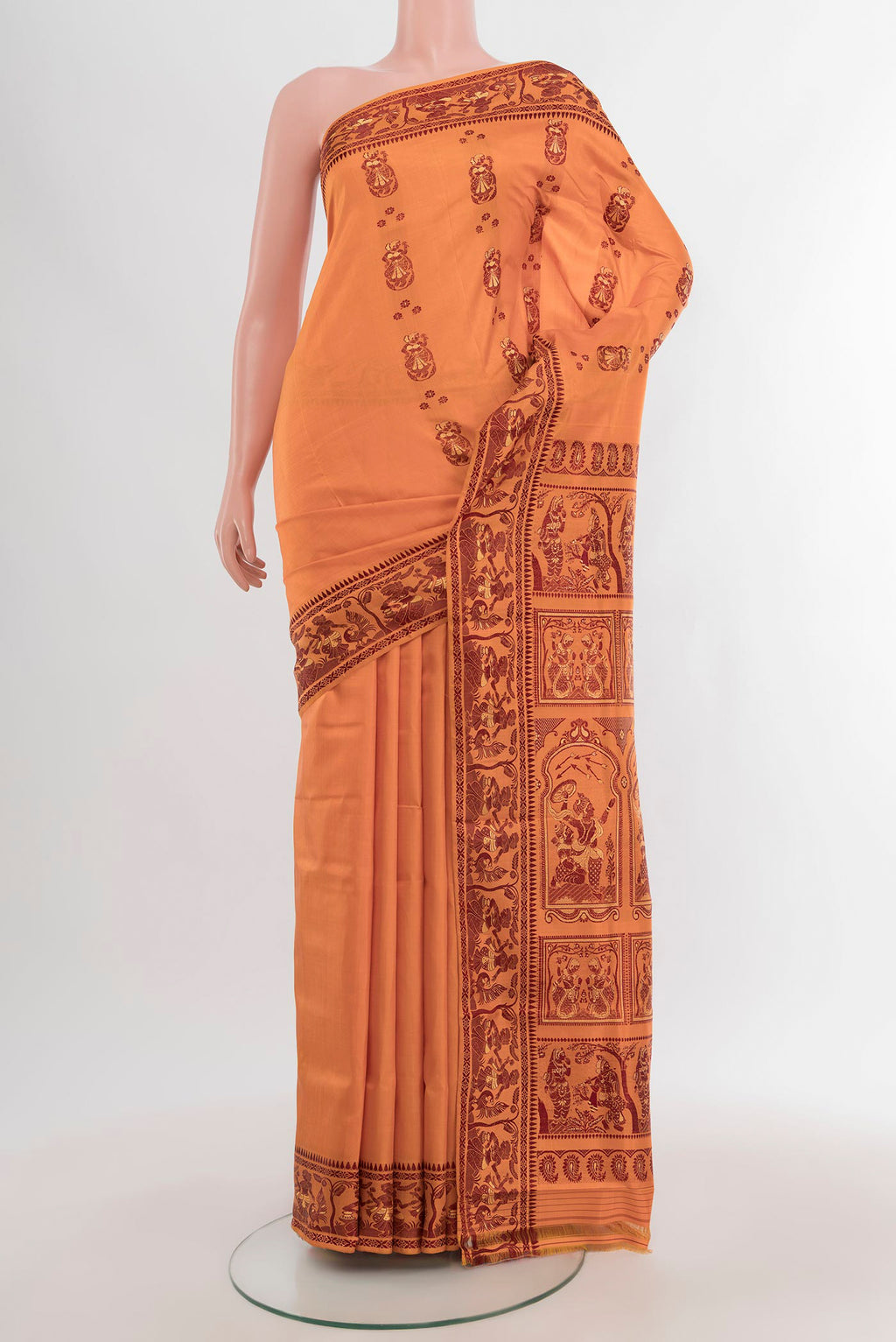 Saffron Baluchari Silk Saree with Thread Butta on the body and Thread Border.  displayed on a mannequin