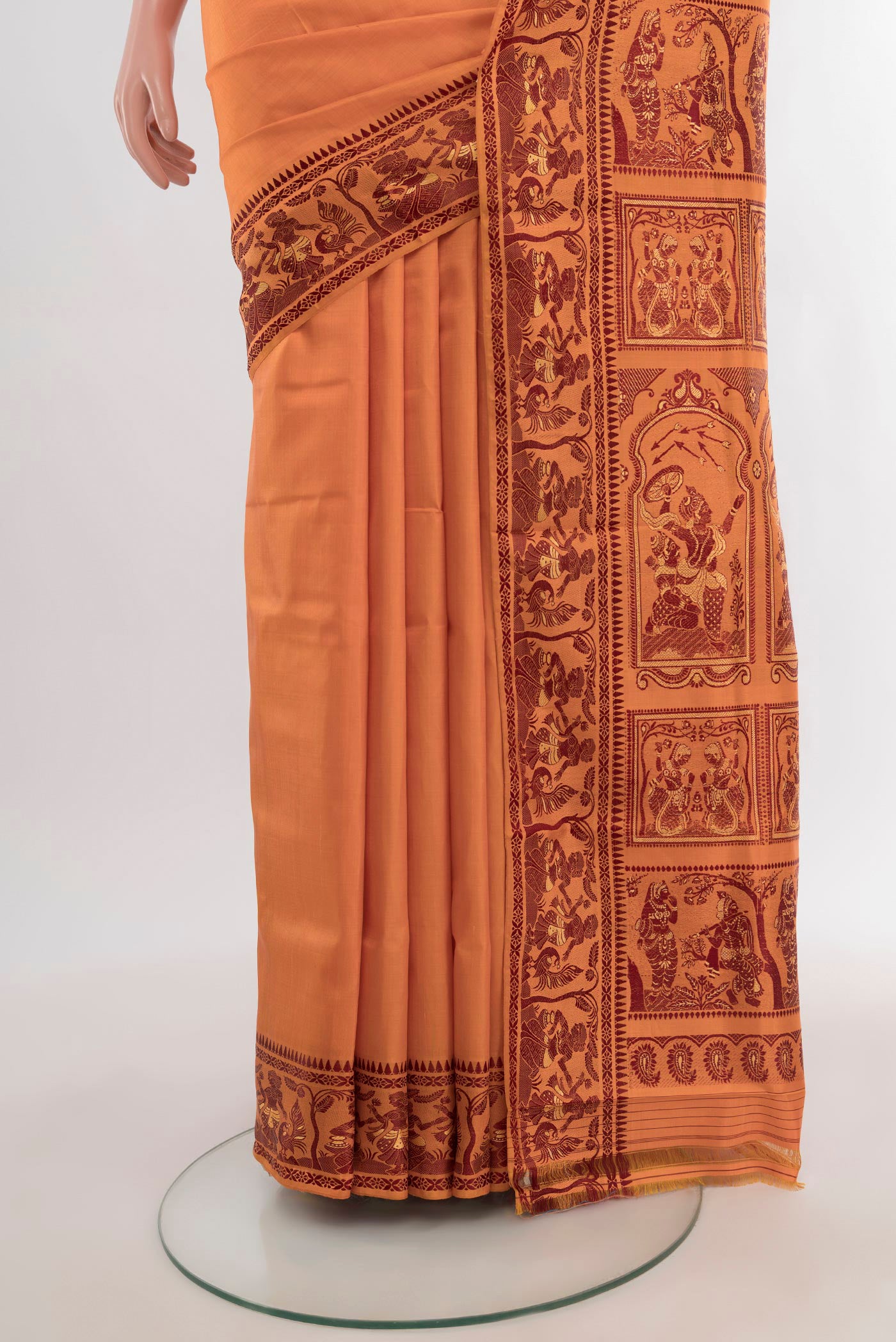 Pleats and pallu of Saffron Baluchari Silk Saree with Thread Butta on the body and Thread Border. 