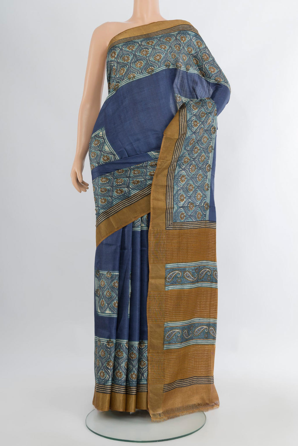 Blue Grey Tussar Silk Saree with Floral Print on the body and Zari Border.  displayed on a mannequin