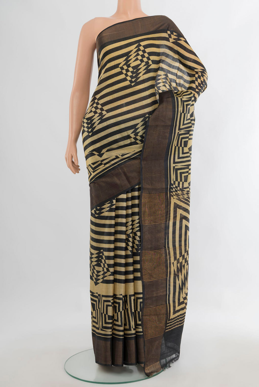Sandal Tussar Saree with Printed design on the body and Zari Border.  displayed on a mannequin