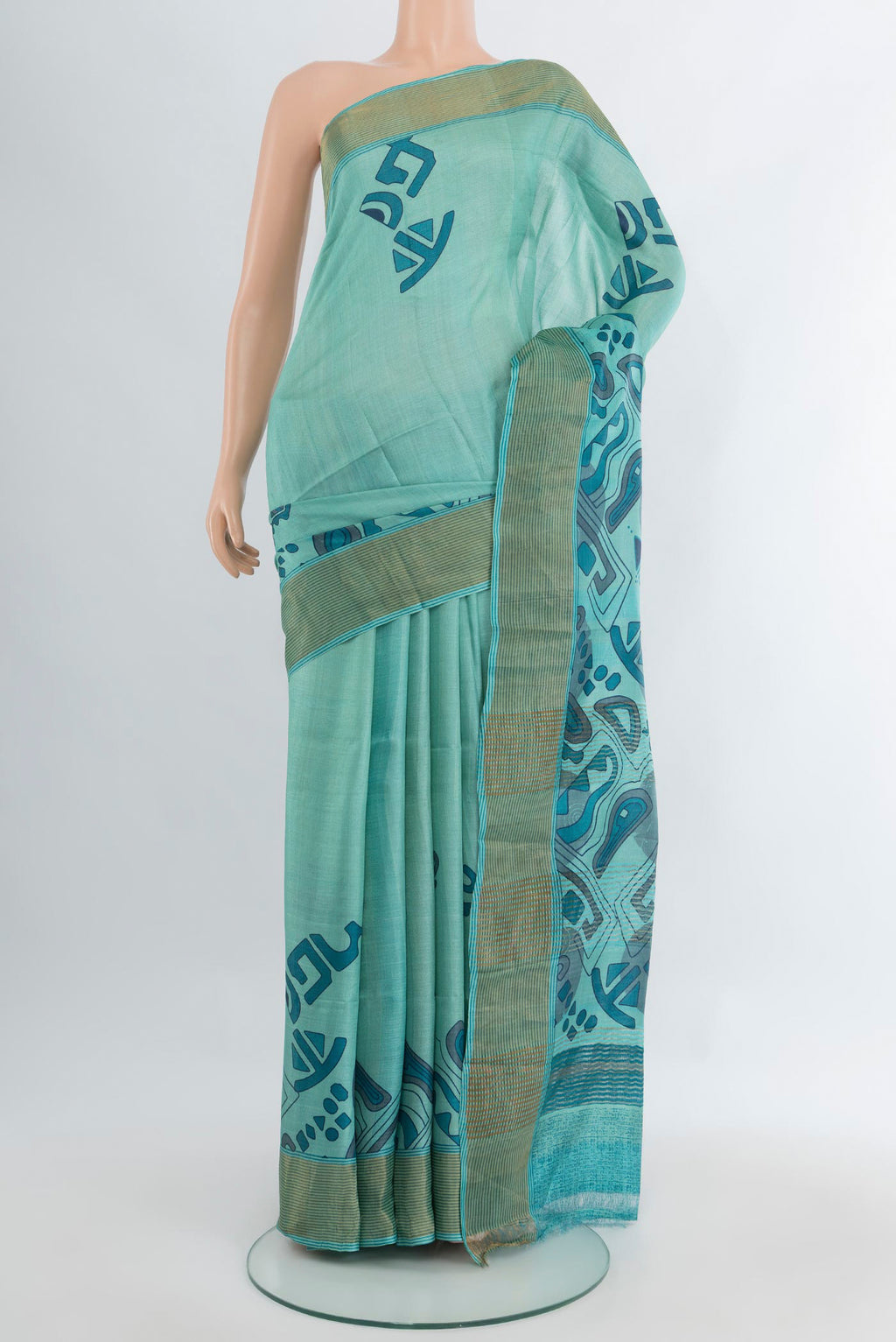 Light Blue Tussar Silk Saree with Floral Print on the body and Zari Border.  displayed on a mannequin