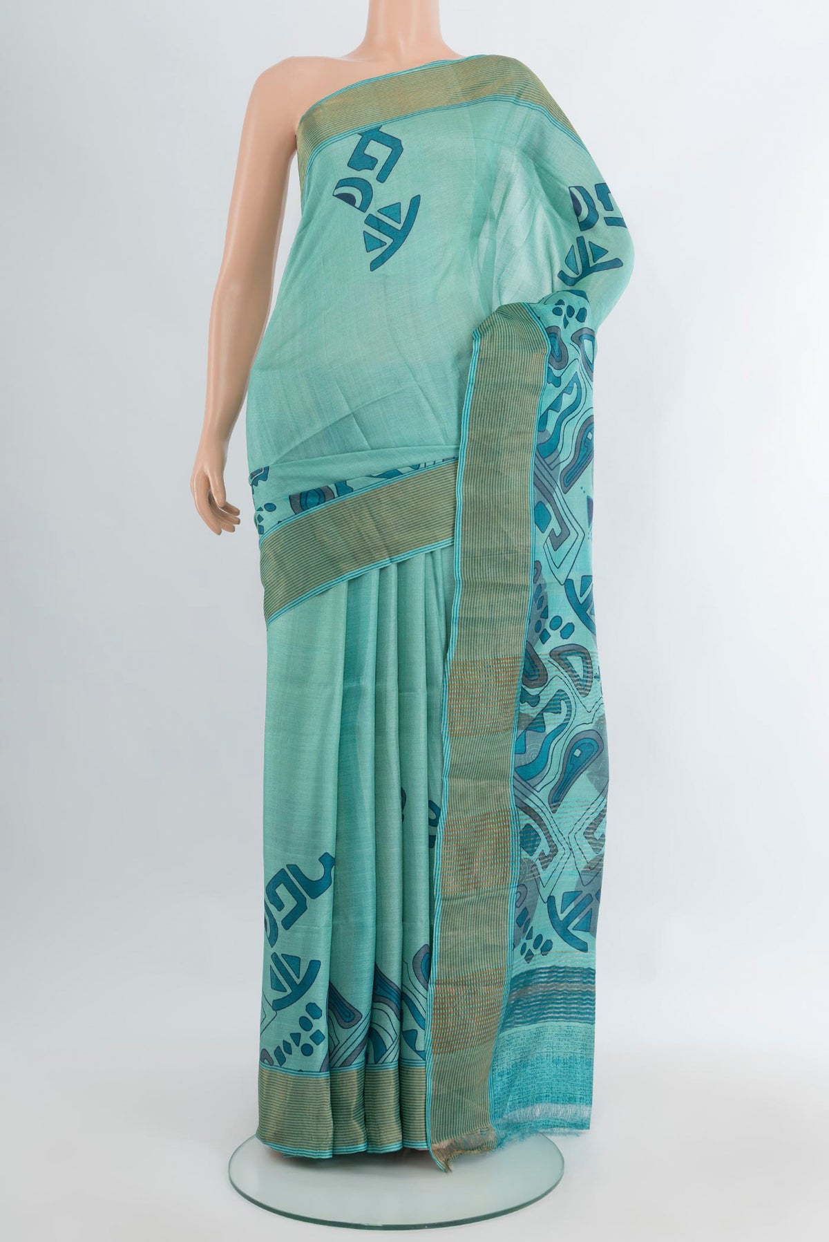 Light Blue Tussar Silk Saree with Floral Print on the body and Zari Border.  displayed on a mannequin