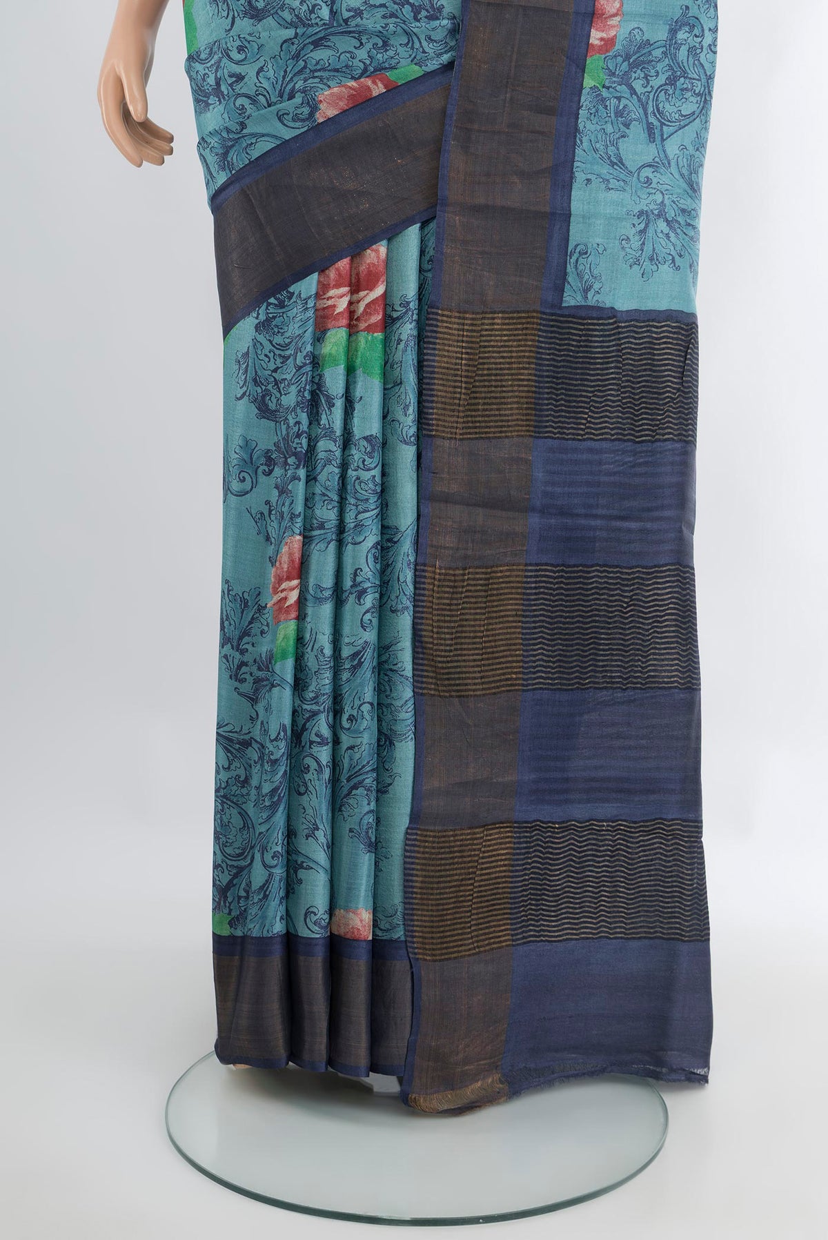 Pleats and pallu of Light Blue Tussar Silk Saree with Floral Print on the body and Zari Border. 