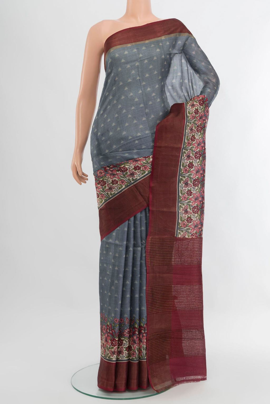 Grey Tussar Silk Saree with Printed design on the body and Zari Border.  displayed on a mannequin