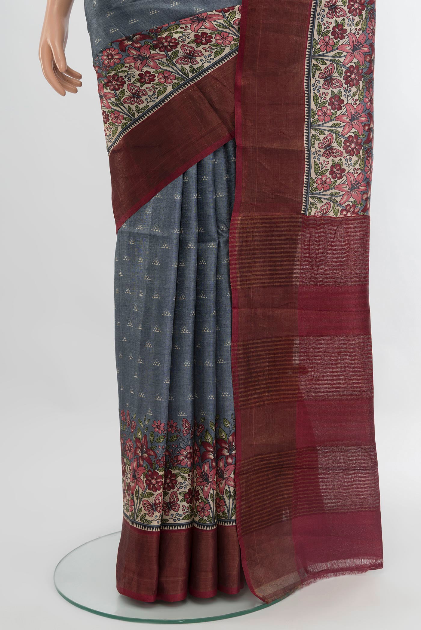 Pleats and pallu of Grey Tussar Silk Saree with Printed design on the body and Zari Border. 