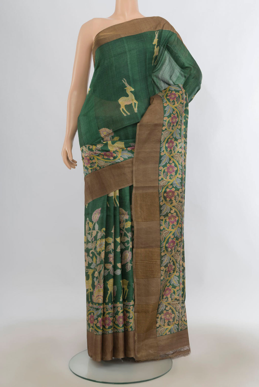 Green Tussar Saree with Printed design on the body and Zari Border.  displayed on a mannequin