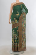 Green Tussar Saree with Printed design on the body and Zari Border.  displayed on a mannequin