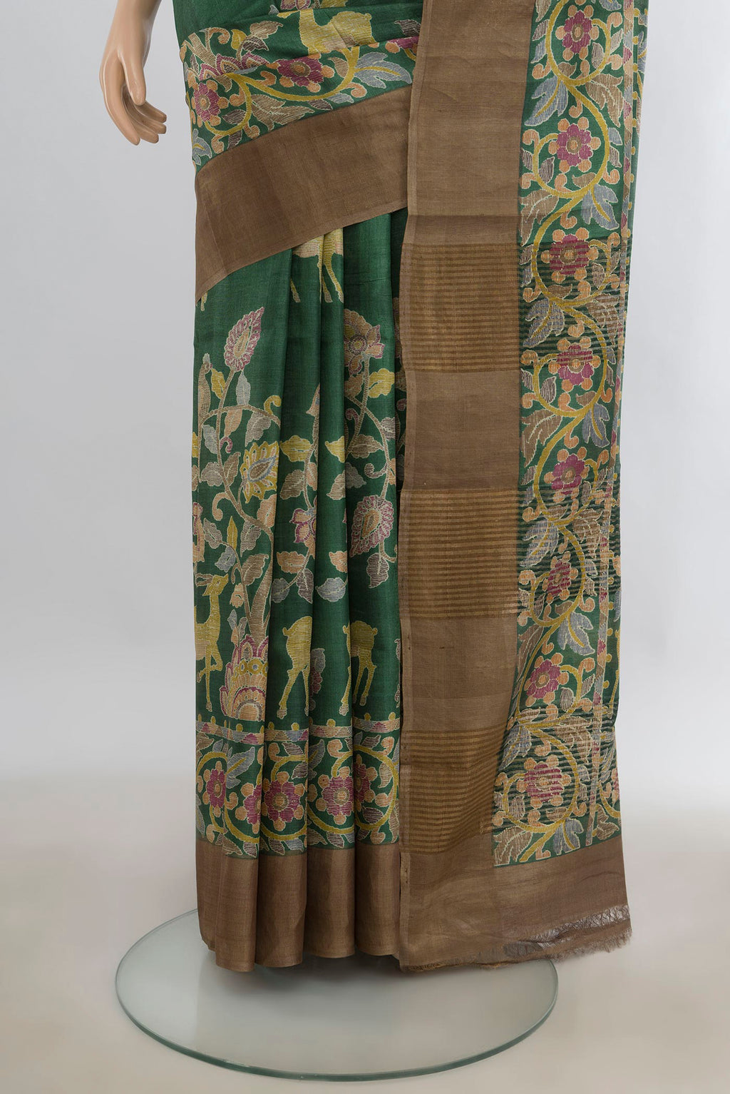 Pleats and pallu of Green Tussar Saree with Printed design on the body and Zari Border. 