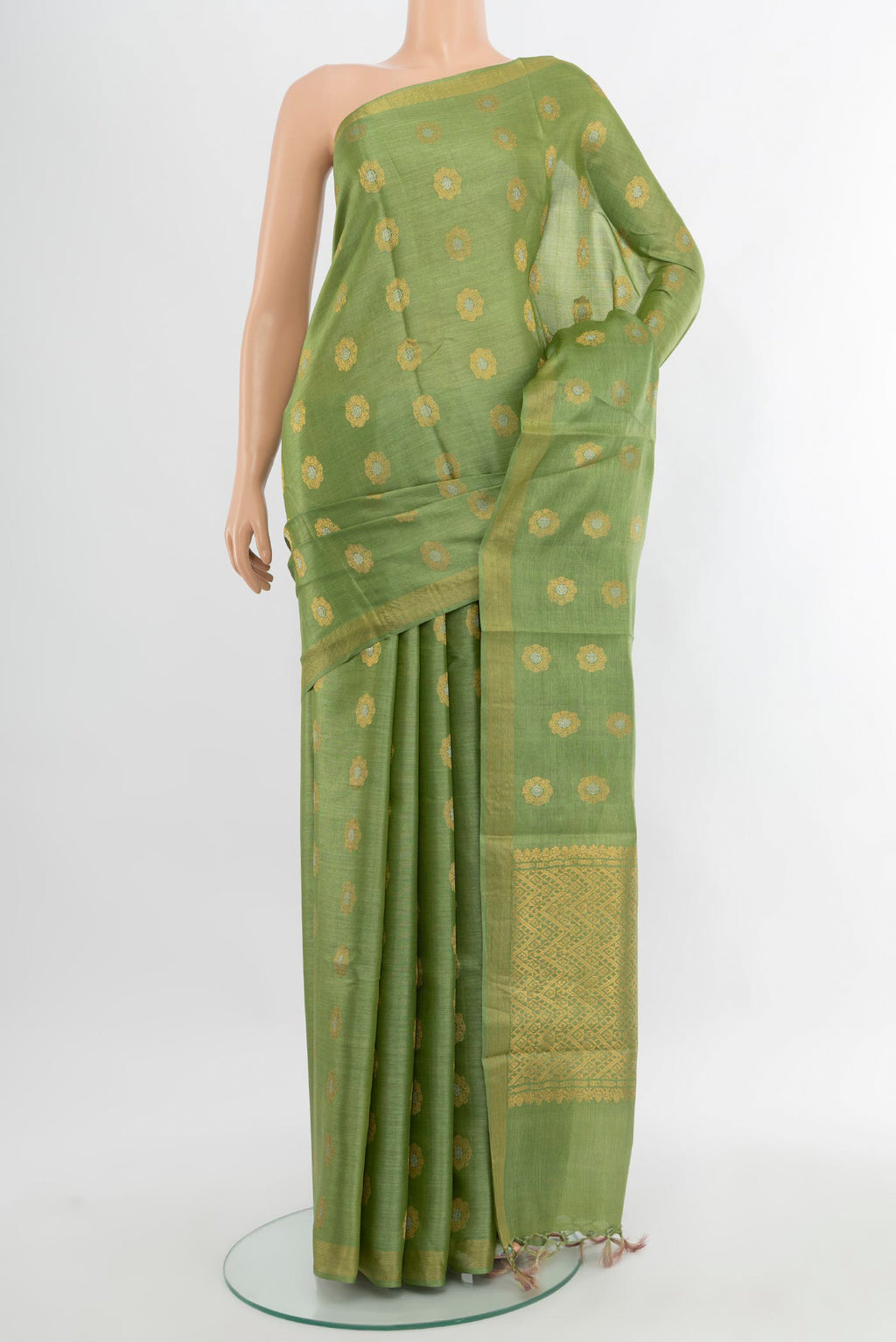Pista Green Tussar Silk Saree with Zari Butta on the body and Zari Border.  displayed on a mannequin