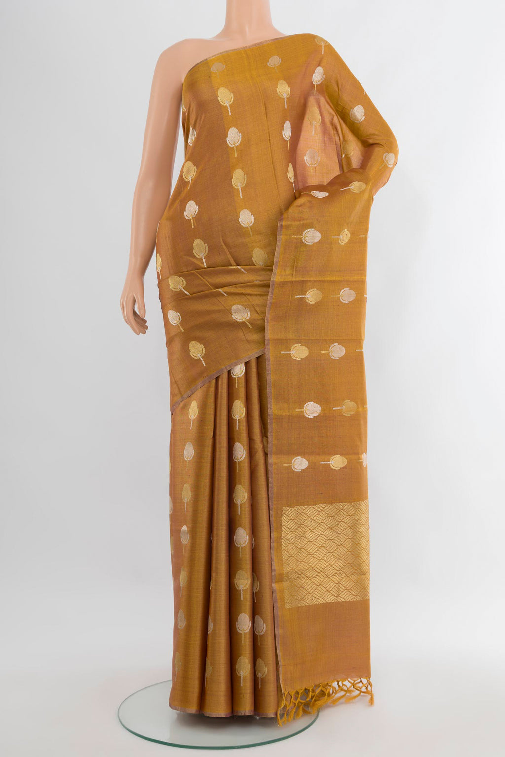 Golden Tussar Silk Saree with Zari Butta on the body and Without Border.  displayed on a mannequin