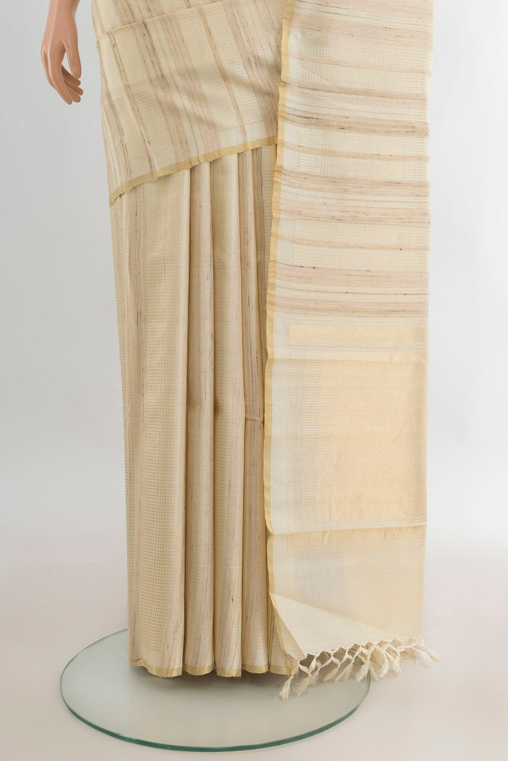 Pleats and pallu of Cream Tussar Saree with Stripes on the body and Zari Border. 