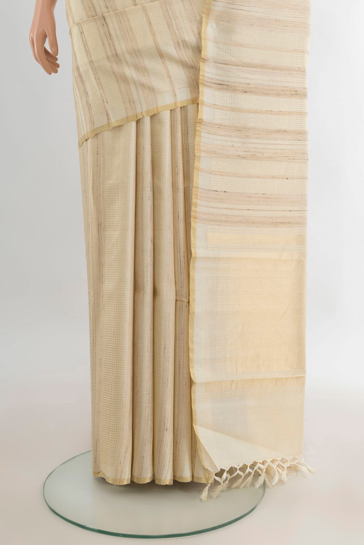 Pleats and pallu of Cream Tussar Saree with Stripes on the body and Zari Border. 