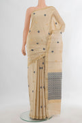 Cream Tussar Saree with Thread Butta on the body and Zari Border.  displayed on a mannequin