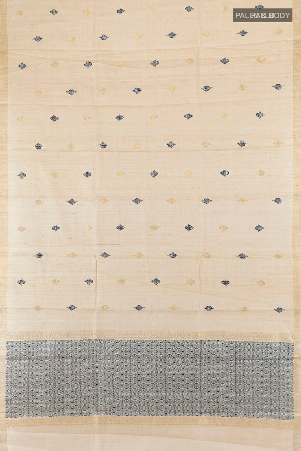 Flat view of Cream Tussar Saree with Thread Butta on the body and Zari Border. 
