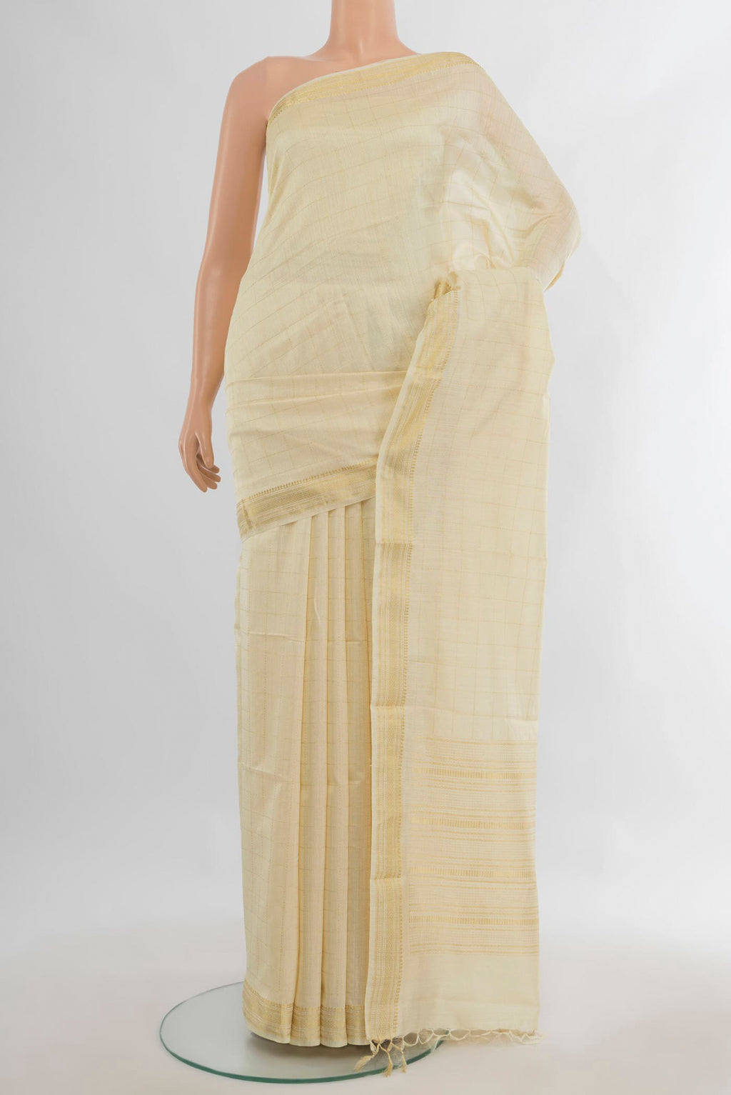 Cream Tussar Saree with Checked design on the body and Zari Border.  displayed on a mannequin
