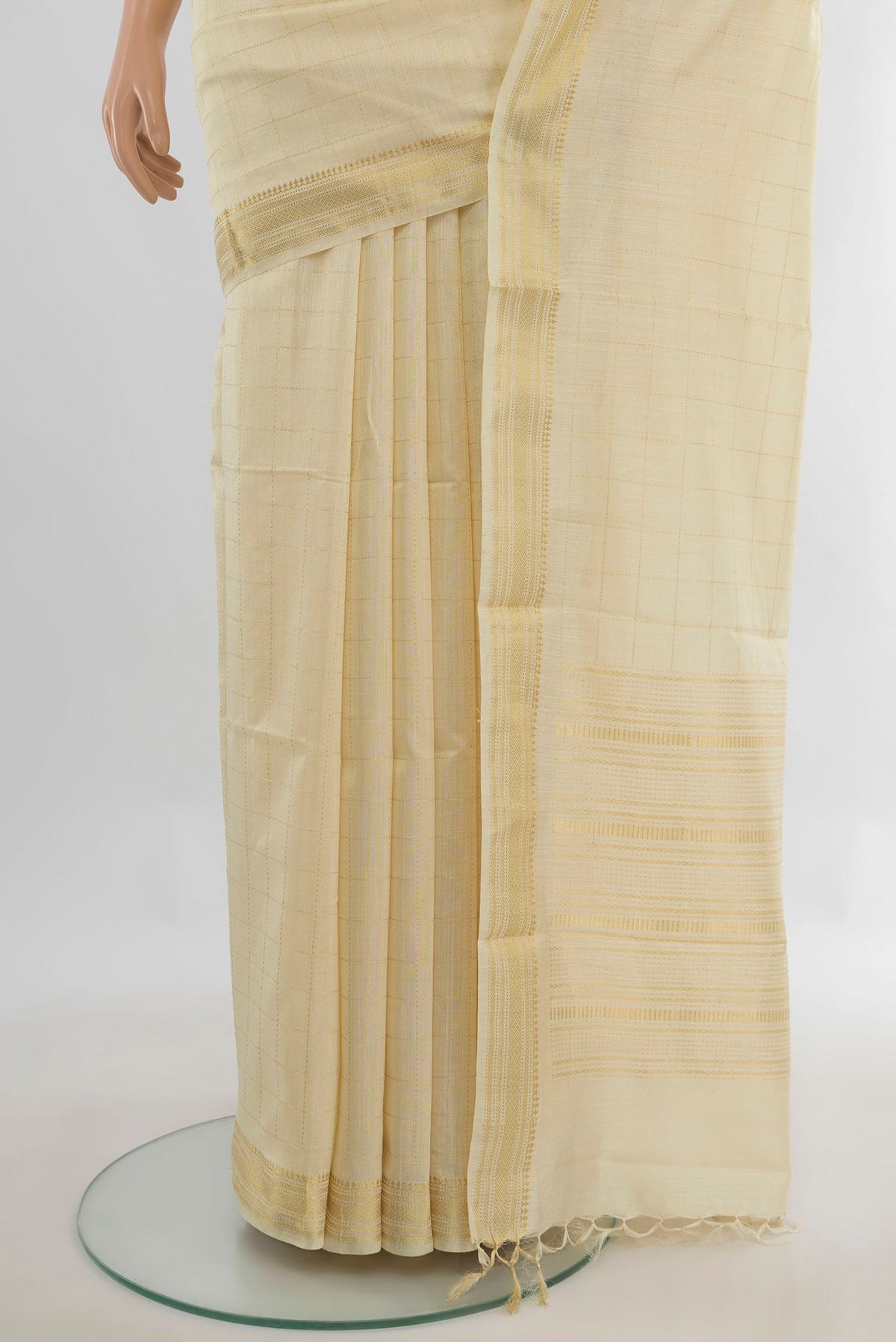 Pleats and pallu of Cream Tussar Saree with Checked design on the body and Zari Border. 
