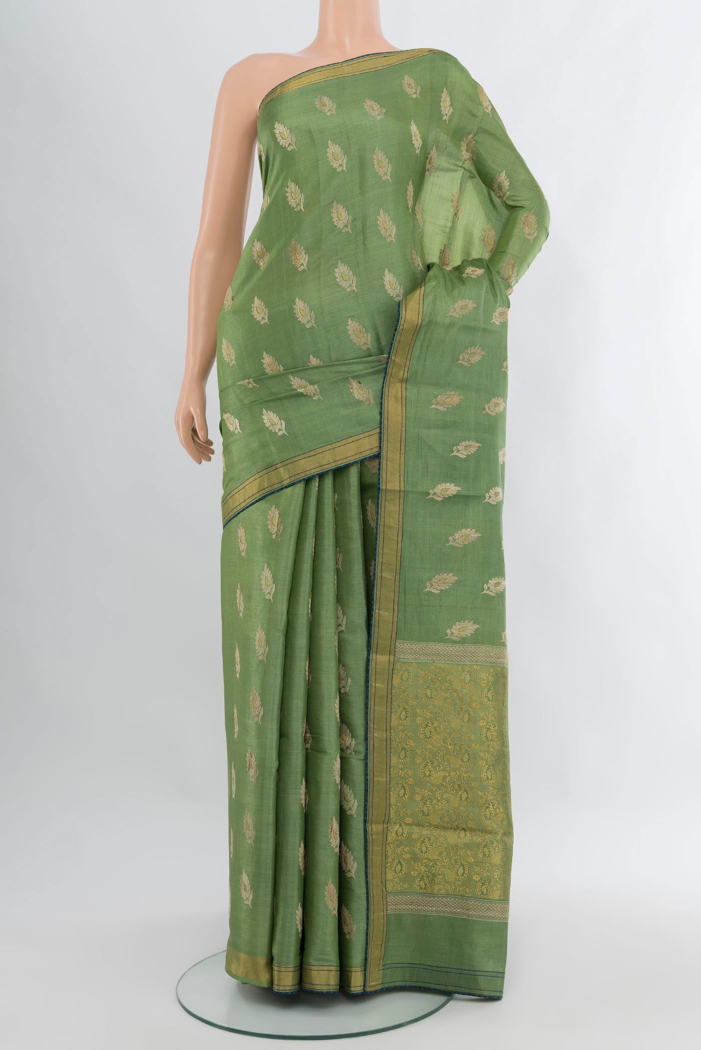 Light Green Tussar Silk Saree with Zari Butta on the body and Zari Border.  displayed on a mannequin
