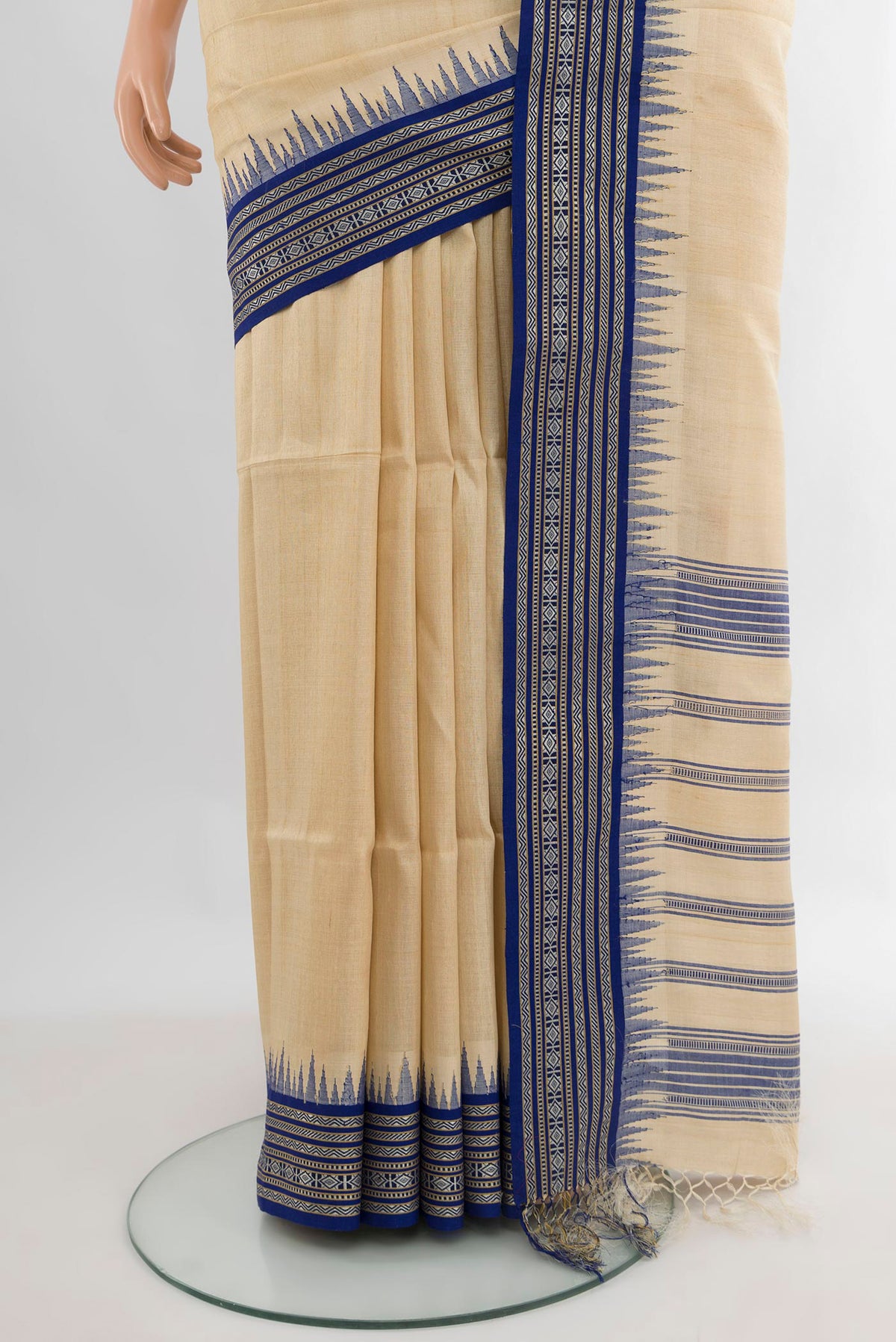 Pleats and pallu of Cream Tussar Saree with Plain Body and Temple Border. 